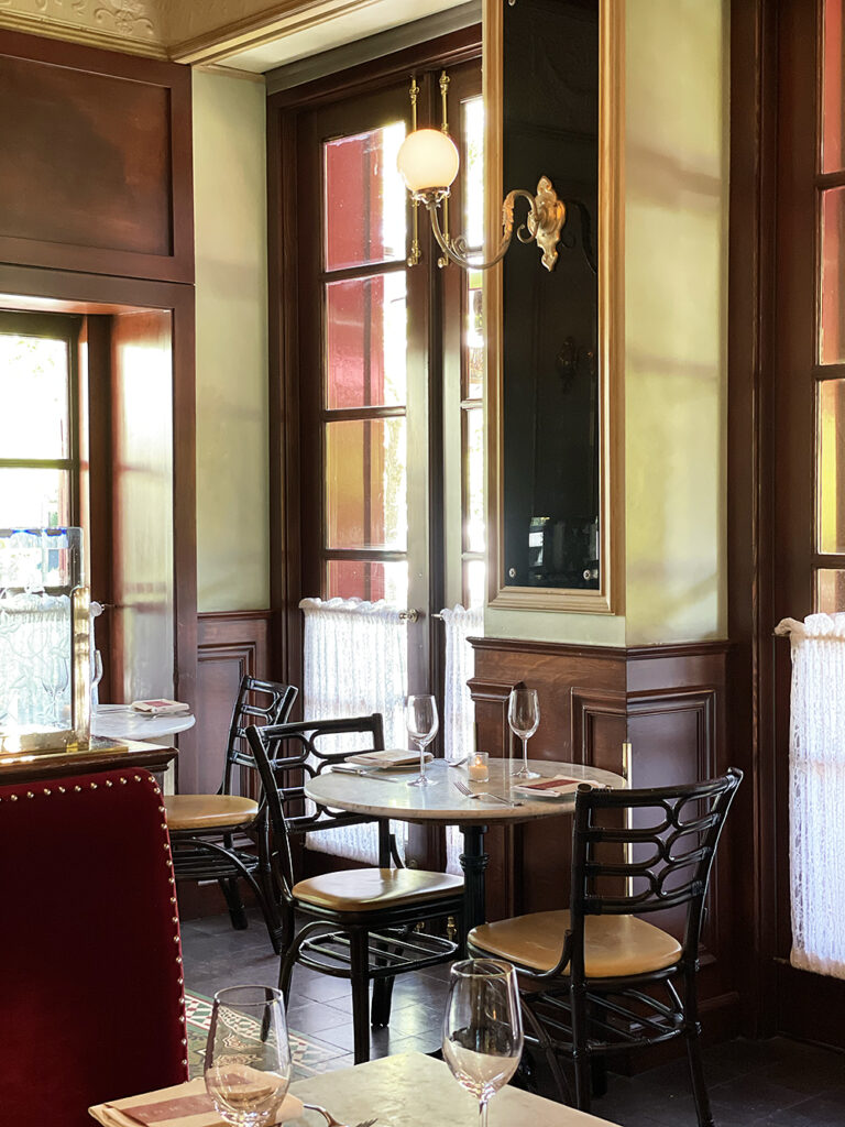 The Inside of a Restaurant at the Golden Hour, an inviting place to sit and pass the time with a glass of wine, food, and loved ones.